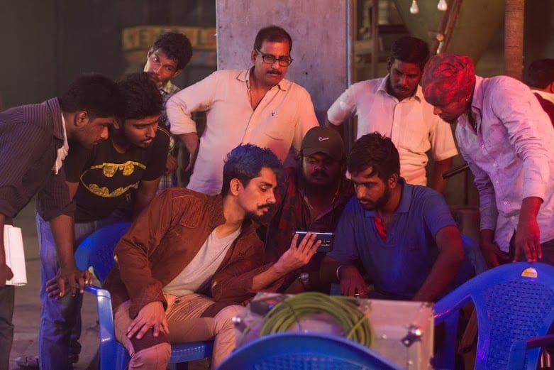 Crew gathered around the monitor on a night shoot